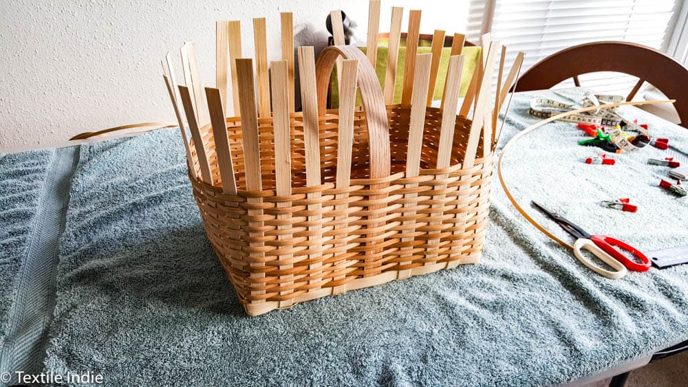 almost finished weaving the walls of a rectangular basket 
