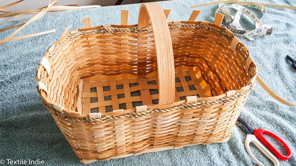 tucking the outside weavers into the basket 