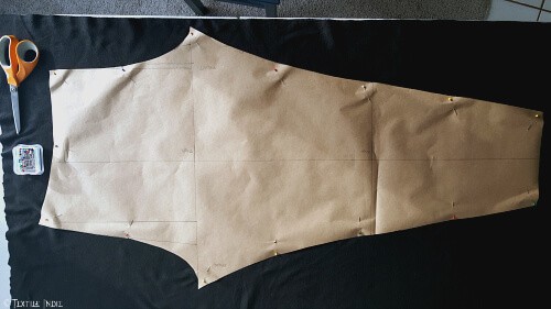 Pinning legging pattern in place on fabric
