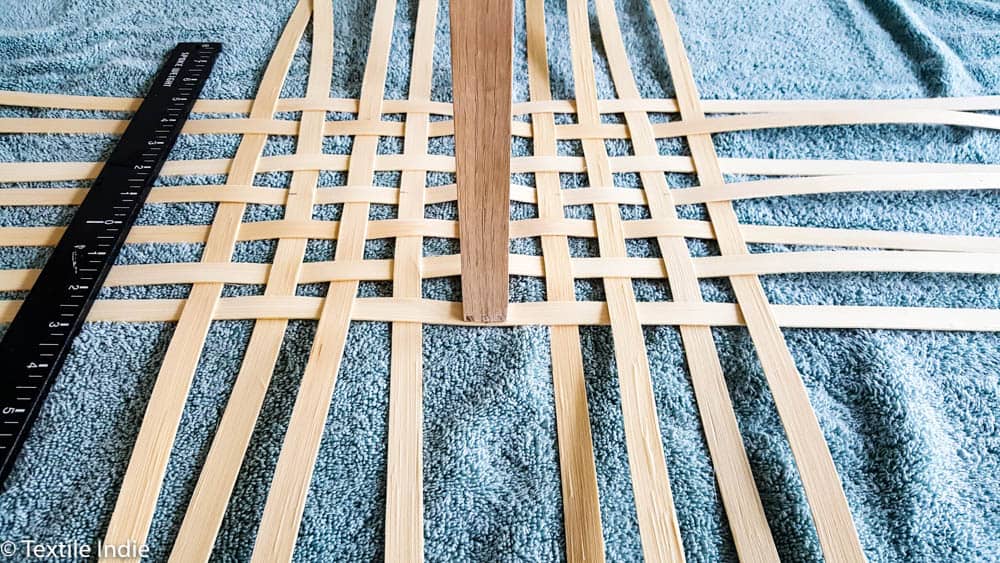 spacing the stakes of an open weave basket base