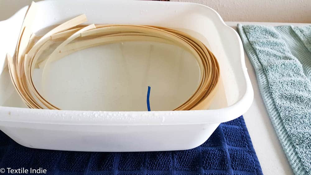 soaking basket reed in a tub of water