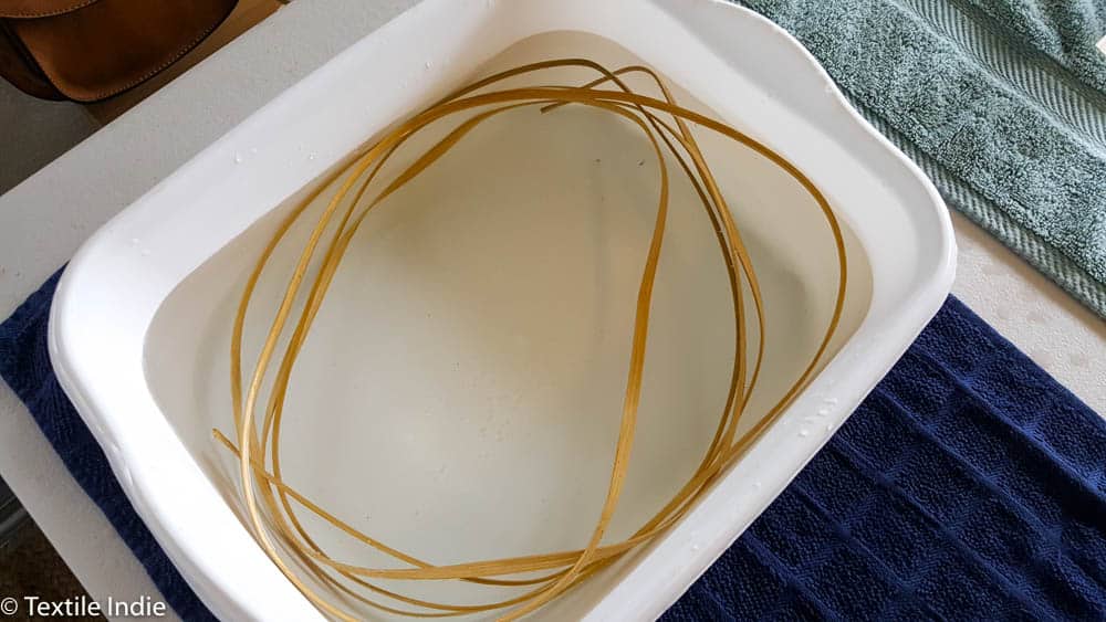 Basket reed soaking in a tub of water.