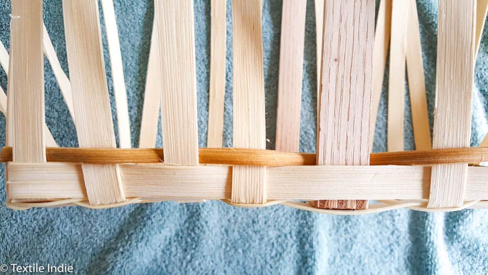 building the walls of a basket with a weaver
