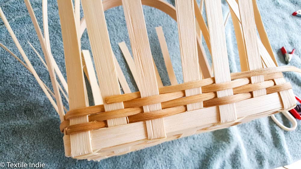 a rattan basket in the process of weaving the walls