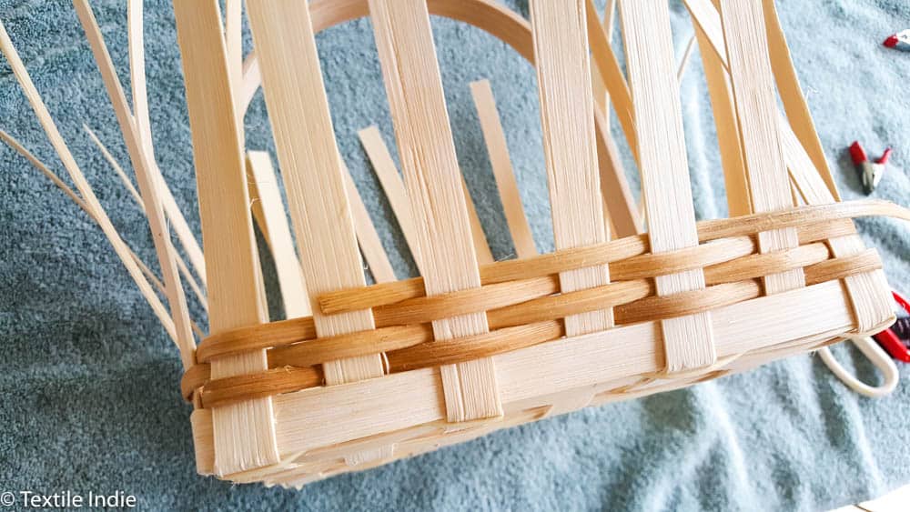 building the walls of a basket with a weaver 