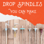 Homemade drop spindles laying on a wood floor.