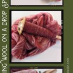 Wood drop spindle with red wool yarn.