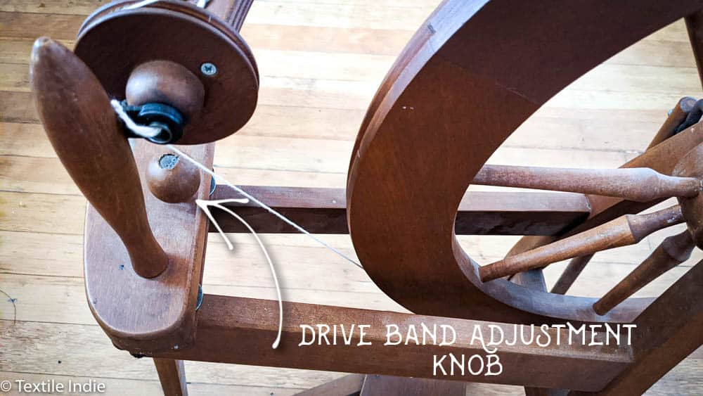 An Ashford Traditional Spinning wheel, detail view showing the drive band adjustment knob