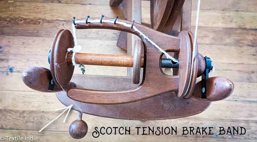 An Ashford Traditional Spinning wheel, detail view of the scotch tension brake band 