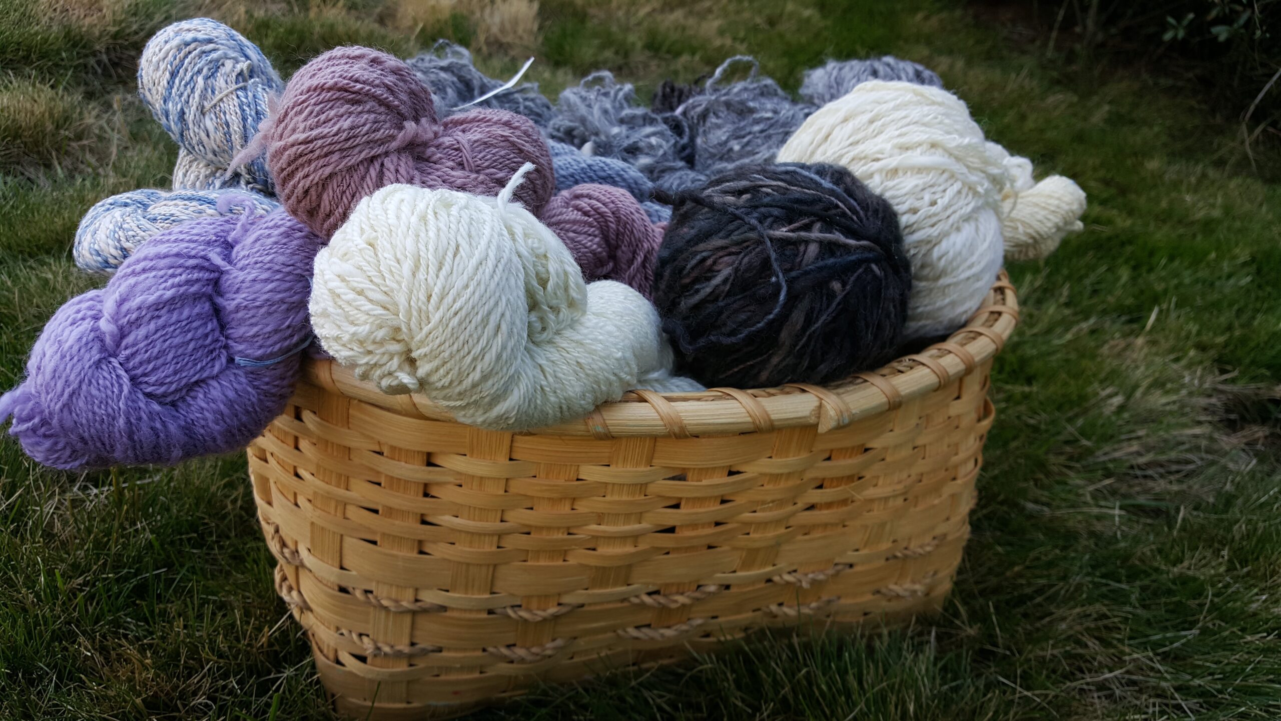 a handmade basket filled with naturally dyed wool yarn