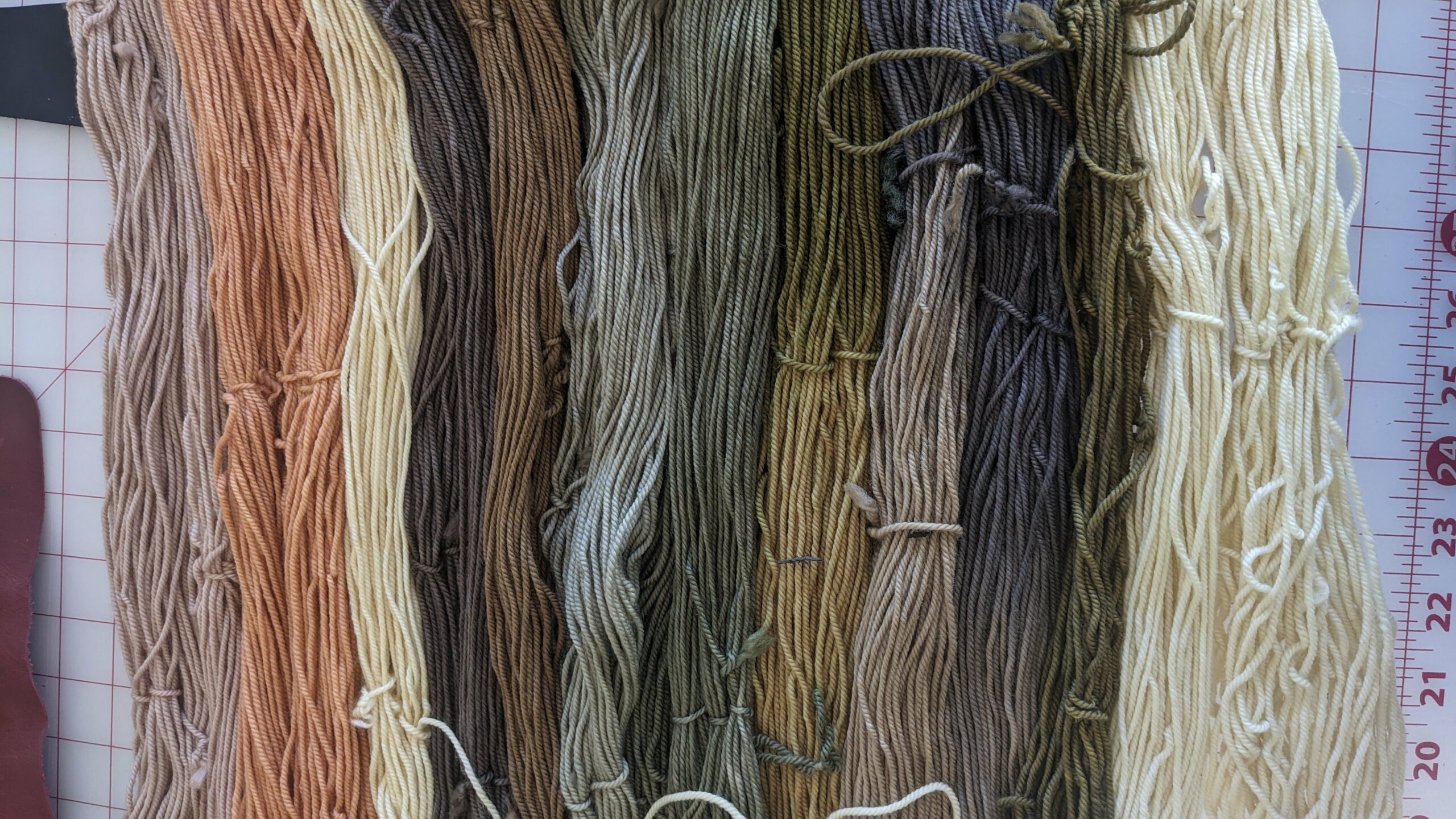 long hanks of naturally dyed wool yarn in pastels and earth tones