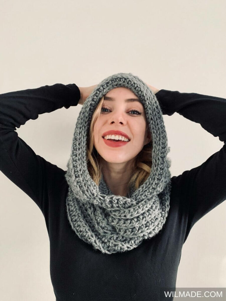 grey hooded scarf on a woman in a black sweater