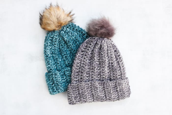 Turquoise and grey toddler hats with pompoms
