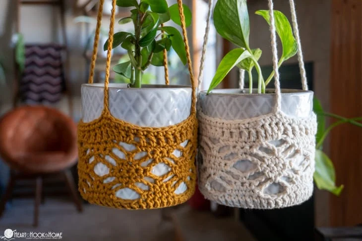 gold and off-white crochet plant hangers with ceramic pots and plants in them
