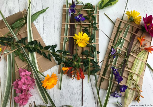 Flowers tied to cardboard in a nature weaving project for children
