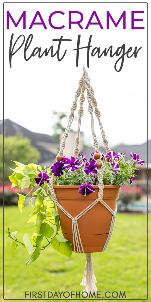 a macrame plant hanger holding a plastic terra cotta pot that is filled with purple and white primroses 