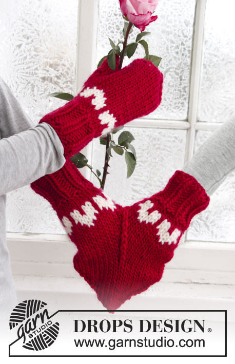 red and white mittens, one mitten is meant to house 2 hands, making it a shared mitten from Drops Design, one hand holds a red rose 