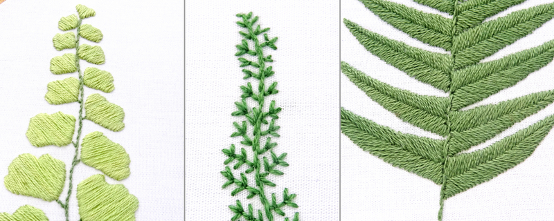 A close-up of an embroidery piece. Three types of fern in three different shades of green are represented