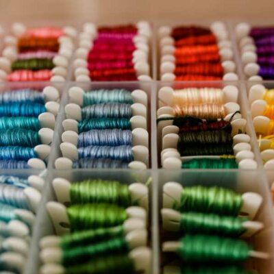 An embroidery floss box filled with colorful cards of embroidery floss