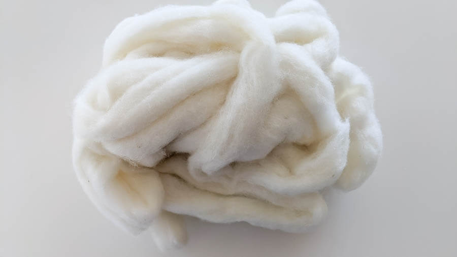 rolled ball of white wool roving