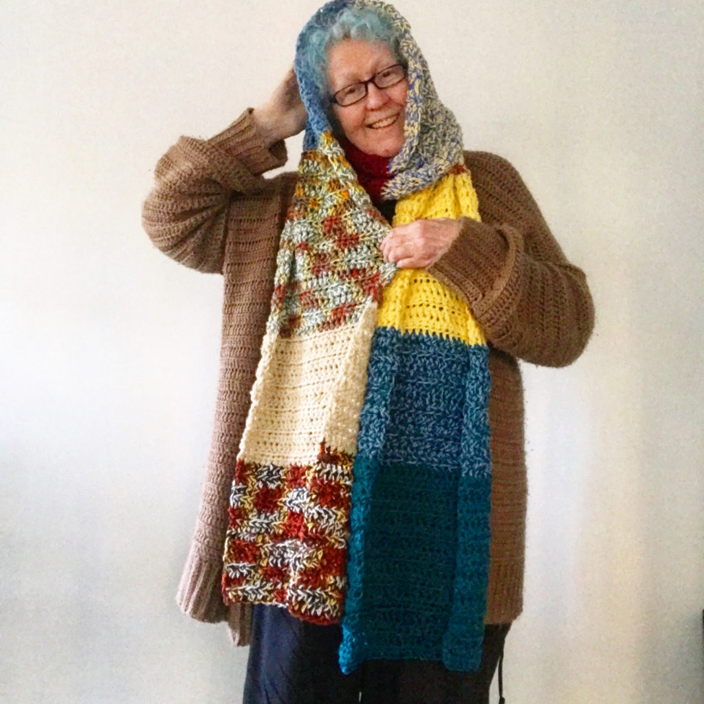 Woman wearing a patchwork crochet scarf 
