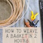 An array of basket weaving tools sit on a towel. The tools include a coil of reed, a straight-tipped packer, tape measure, clamps, reed snips, and a stake weight.